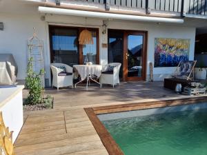 a patio with a table and a swimming pool at Studio 22, Terrasse,Pool,Sauna,Ofen in Neuffen