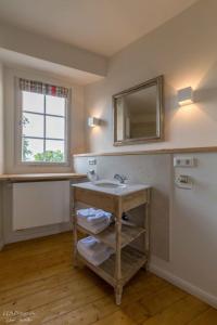 a bathroom with a sink and a mirror at Apartment Lindenplatz in Langenburg