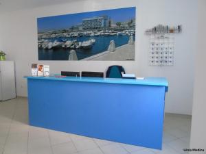 a blue counter in a room with a picture of a harbor at Hotel Adelaide in Faro