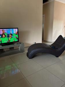a black bean bag chair in front of a tv at Gardenlea in Durban