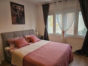 a bedroom with a bed and a window at apartman Frida in Zagreb