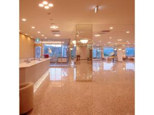 a large lobby with a reception desk and glass walls at Kesennuma Plaza Hotel - Vacation STAY 15381v in Kesennuma