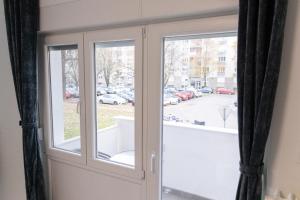 a glass door with a view of a parking lot at Maris in Osijek