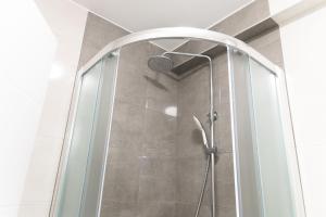 a shower with a glass door in a bathroom at Maris in Osijek