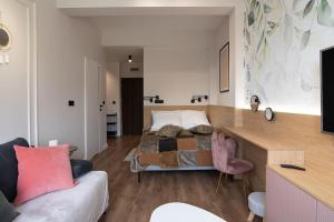 a bedroom with a bed and a couch in a room at Apartament By Miło Było in Ustroń