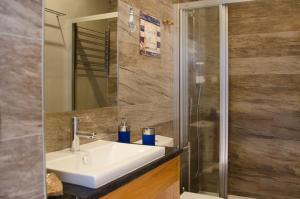 a bathroom with a sink and a shower at Porto N&aacute;utico & Spa in Porto