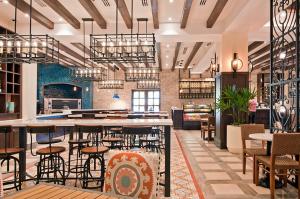 a restaurant with tables and chairs in a room at Stunning 3BR Condo with Ocean Views, Golf Course & Resort Amenities in Cabo San Lucas