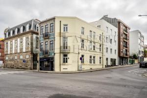 a row of buildings on a city street at Alberti's House Oporto Central Apartment in Porto