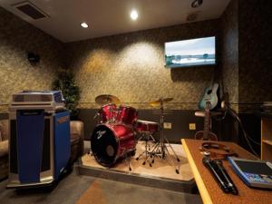 a recording studio with a drum kit and a tv at Business Green Hotel Hino - Vacation STAY 16322v in Hino
