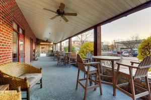 a patio with tables and chairs and a ceiling fan at Stoney Creek Hotel Moline in Moline