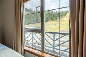 a room with a window with a view of a road at Sundance Lodge in Sun Peaks