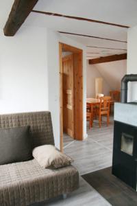 a living room with a couch and a fireplace at Ferienwohnung Kaim in Prichsenstadt