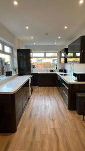 a kitchen with wooden floors and a large kitchen with counters at Sandy Shores Holiday Home in Cleethorpes