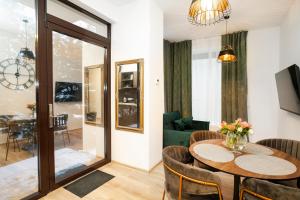 a living room with a table and a couch at Central Station Apartment No1 in Kaunas