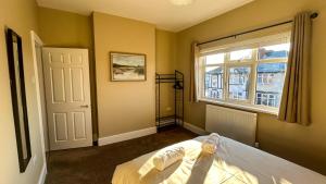 a bedroom with a bed and a window at Sandy Shores Holiday Home in Cleethorpes