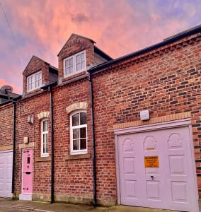 a brick building with two garages and two garage doors at Longsands Hideaway in Tynemouth