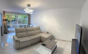 a living room with a couch and a table at RESIDENCE SERENA in Torcy