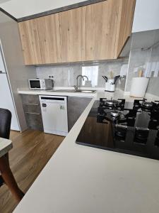 a kitchen with a black and white stove top oven at Luxury Apartment POOL SPA GYM 1+1 in Antalya