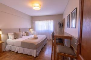 a bedroom with a bed and a desk and a table at El Misti Coliving Obelisco in Buenos Aires