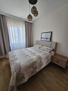 a bedroom with a large bed and a window at Luxury Apartment POOL SPA GYM 1+1 in Antalya