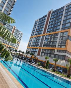 a swimming pool in front of a building at Luxury Apartment POOL SPA GYM 1+1 in Antalya