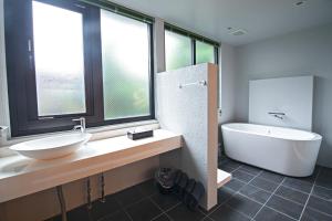 a bathroom with a sink and a tub and a toilet at KyotoGosyonishi - Vacation STAY 22739v in Kyoto