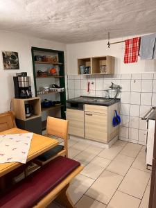 a kitchen with a table and a table and a table and a kitchen at Ferienwohnung Bauernhaus Untermoas in Abtenau