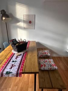 a wooden table with a basket on top of it at Luxury Townhouse, Manchester Sleeps 6 in Manchester