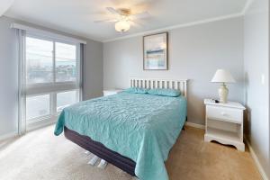 a bedroom with a bed and a large window at Makai 108 in Ocean City