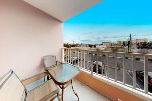 a balcony with a chair and a view of a street at Makai 108 in Ocean City