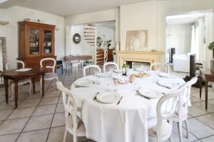 a dining room with a white table and chairs at Charming house with garden in Sèvres - Welkeys in Sèvres