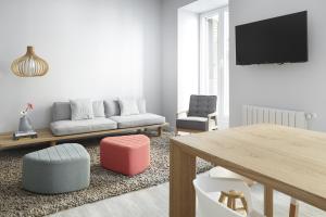 sala de estar con sofá, mesa y sillas en Soraluxe by FeelFree Rentals en San Sebastián