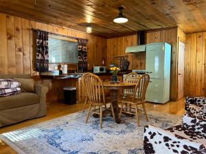 a kitchen with a table and chairs and a refrigerator at Lakeshore Resort in Lakeshore