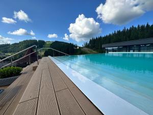 a large pool of water with a building at SAVOIE Apartments Bukovel in Bukovel