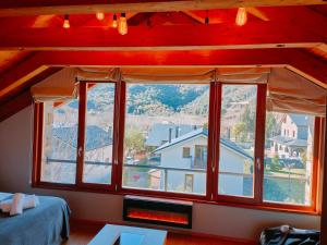 a room with a large window with a fireplace at Can Congost in Sort