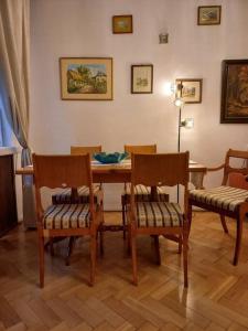 a dining room with a wooden table and chairs at Apartamenty - MI Stare Miasto in Warsaw