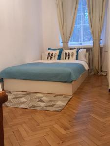 a bed in a bedroom with a window at Apartamenty - MI Stare Miasto in Warsaw