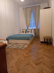 a bedroom with a bed and a wooden floor at Apartamenty - MI Stare Miasto in Warsaw
