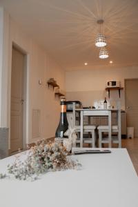 a bottle of wine sitting on a table in a kitchen at Robinson Alojamientos - Edificio Erico Orlando in Ushuaia