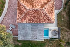 an overhead view of a house with a swimming pool at Stone build suite with private pool in Kolios