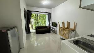 eine Küche mit einem Waschbecken, einem Stuhl und einem Fenster in der Unterkunft Phuket naka Condon-13-45免费高速上网免费停车位 in Phuket