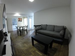 a living room with a couch and a table at Torre Angel - Fragueiro 325 in Córdoba