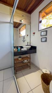 a bathroom with a sink and a mirror at Reduto do Alto in Búzios