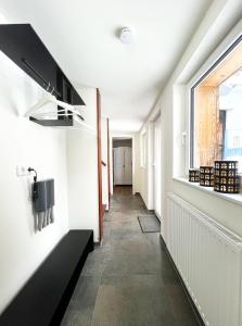a hallway with a window and a long corridor at Ferienhaus Zum Lochstein - FW Gesindehaus in Sankt Andreasberg