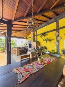 a living room with a table with a rug on it at Reduto do Alto in Búzios +94 photos