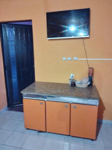 a kitchen with a counter top with a picture on the wall at CASA EN TAFI DEL VALLE ZONA LA ANGOSTURA in San Miguel de Tucumán