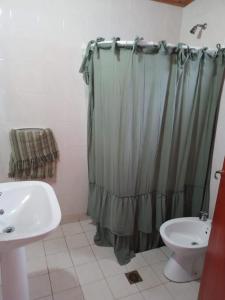 a bathroom with a shower curtain and a sink at CASA EN TAFI DEL VALLE ZONA LA ANGOSTURA in San Miguel de Tucumán