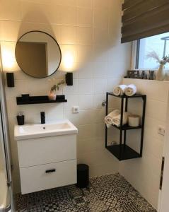 a bathroom with a sink and a mirror at MILANA Naturpanorma, ruhig & familienfreundlich in Winterberg