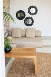 a living room with a couch and a table at Stone build suite with private pool in Kolios