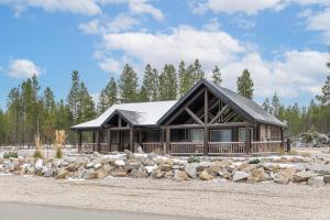 a log cabin with a pile of rocks at Lazy Moose in Valemount